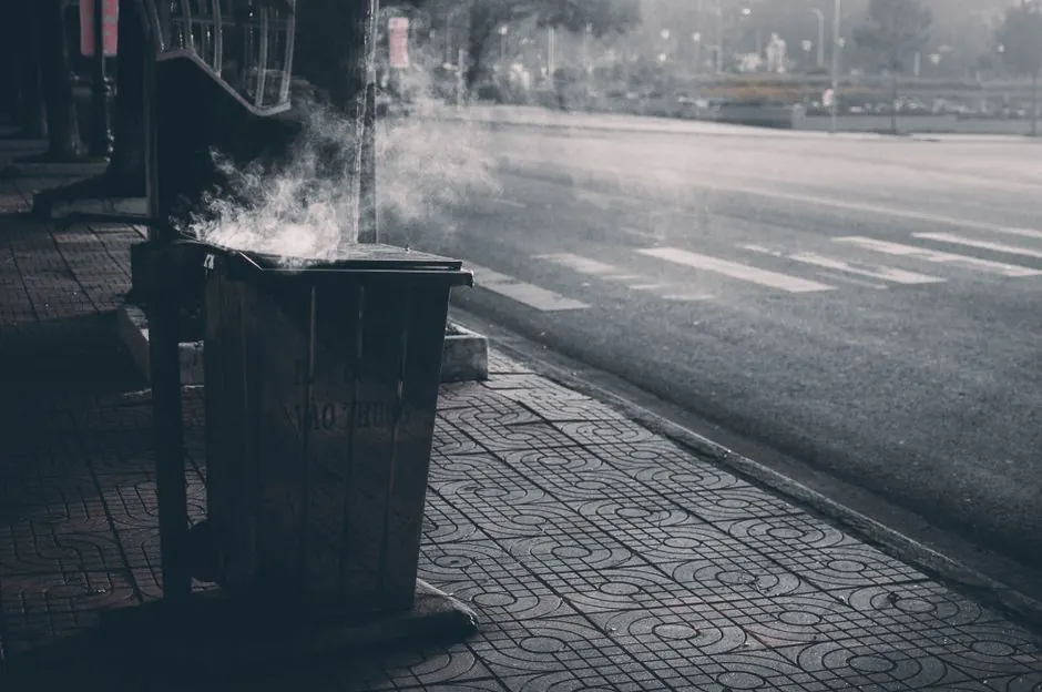 A steaming garbage can on a quiet sidewalk in Buon Ma Thuot, Vietnam.